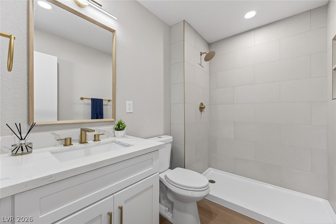 2484 Anglia Street Las Vegas, NV 89142 - Photo 11 of 20 This modern bathroom features a stylish vanity, sleek shower, and ample lighting.