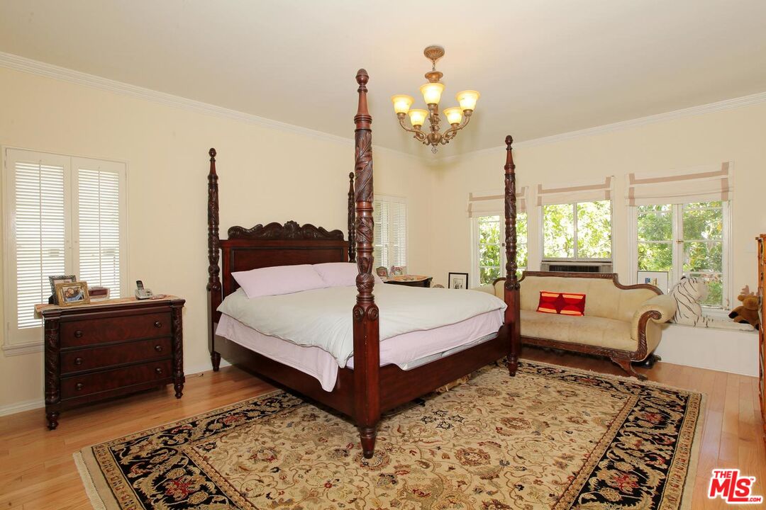 602 North Camden Drive Beverly Hills, CA 90210 - Photo 11 of 18 a bedroom with a bed and wooden floor