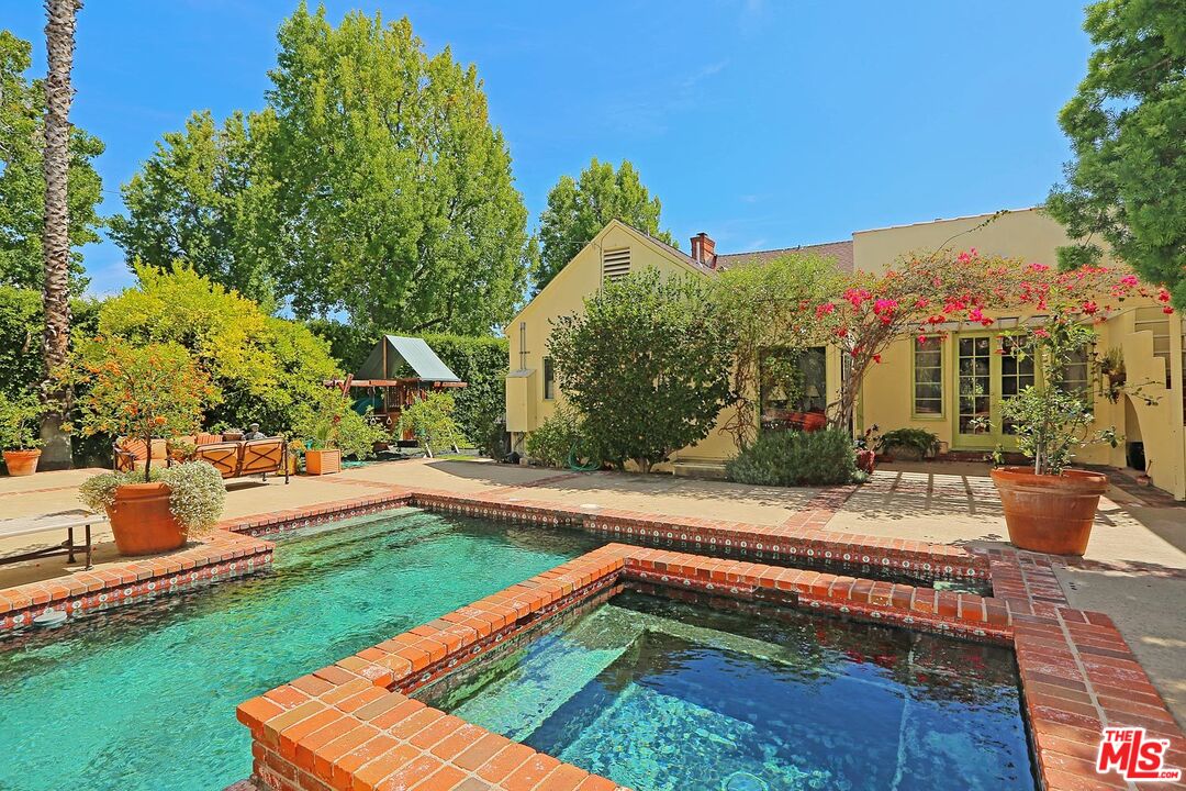 602 North Camden Drive Beverly Hills, CA 90210 - Photo 15 of 18 a view of a backyard with plants and a patio