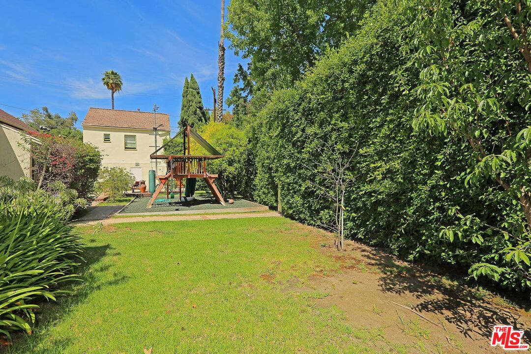 602 North Camden Drive Beverly Hills, CA 90210 - Photo 18 of 18 a view of a swimming pool with lawn chairs under an umbrella