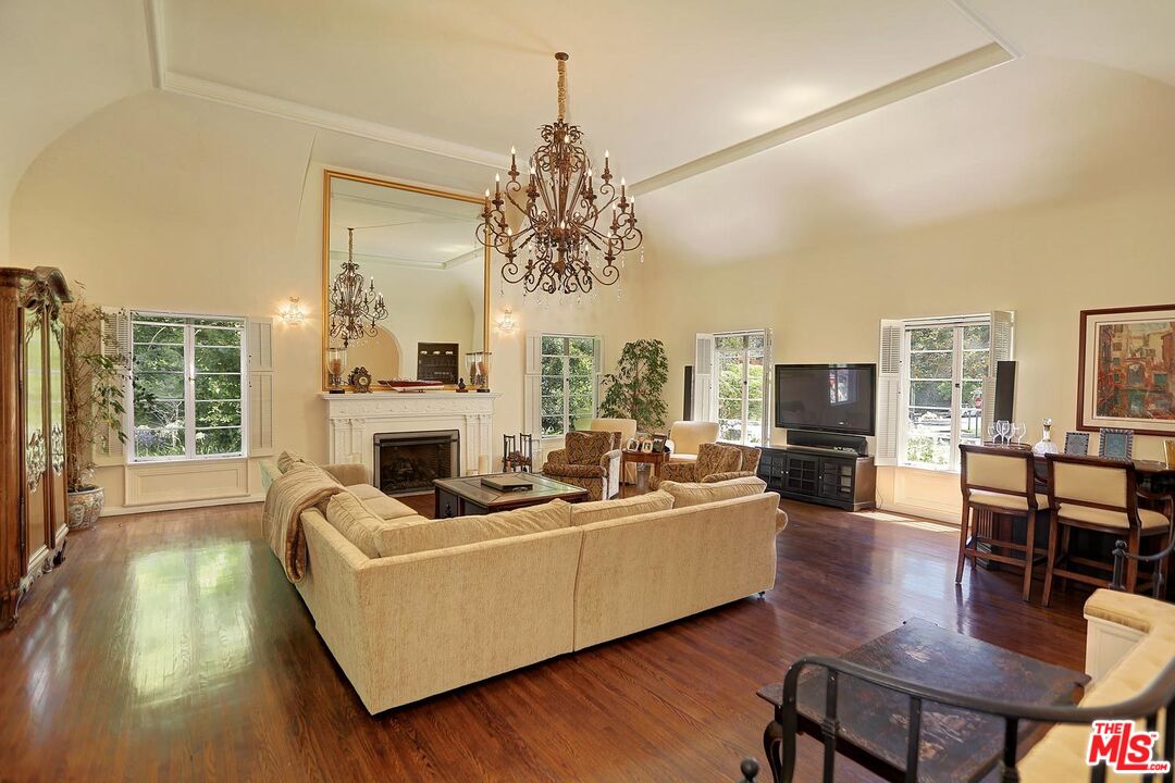 602 North Camden Drive Beverly Hills, CA 90210 - Photo 2 of 18 a living room with fireplace furniture and a large window