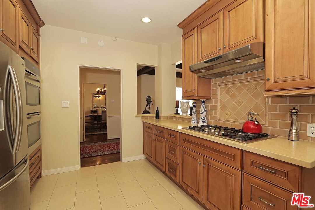 602 North Camden Drive Beverly Hills, CA 90210 - Photo 6 of 18 a kitchen with stainless steel appliances a sink and cabinets
