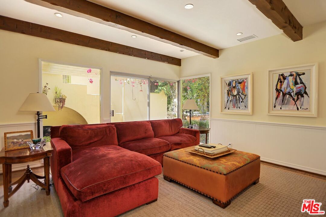 602 North Camden Drive Beverly Hills, CA 90210 - Photo 7 of 18 a living room with furniture and a large window