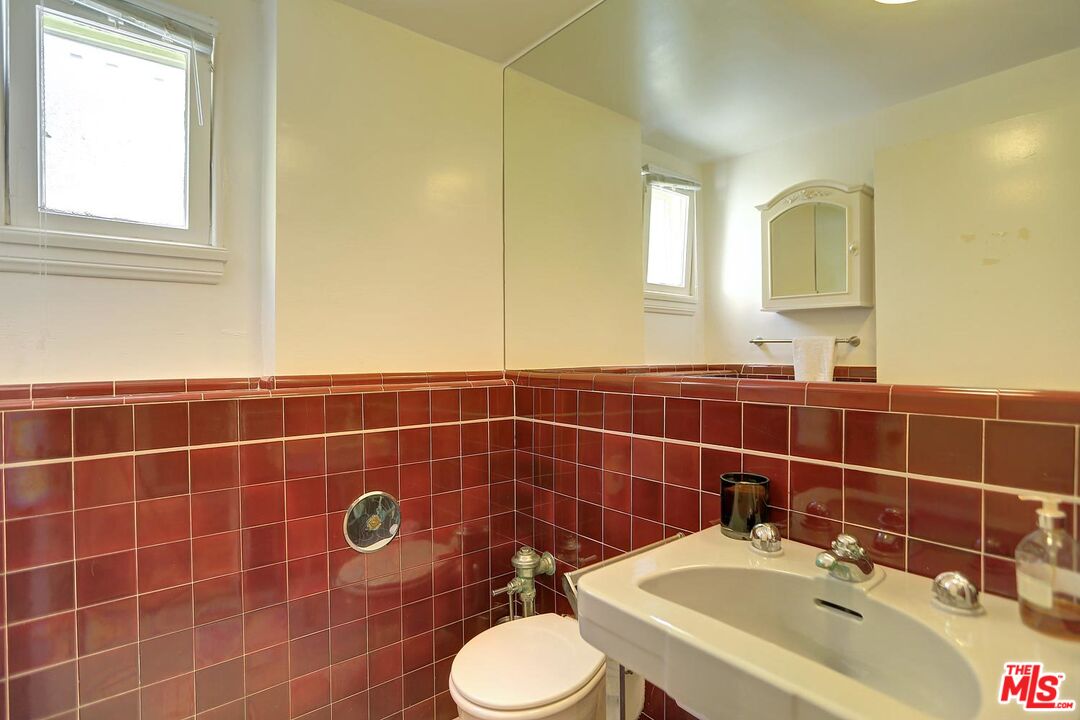 602 North Camden Drive Beverly Hills, CA 90210 - Photo 8 of 18 a bathroom with a sink toilet and a mirror