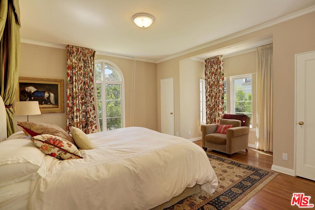 602 North Camden Drive Beverly Hills, CA 90210 - Photo 9 of 18 a bedroom with a bed and wooden floor