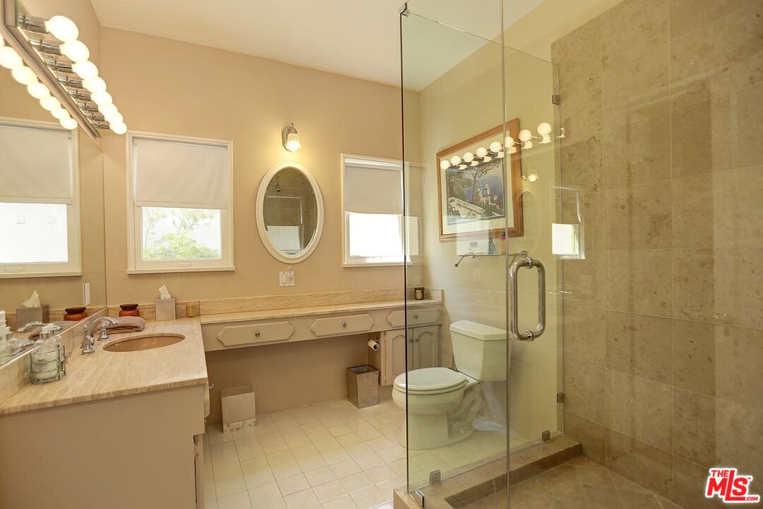 602 North Camden Drive Beverly Hills, CA 90210 - Photo 10 of 18 a bathroom with a sink a toilet and shower