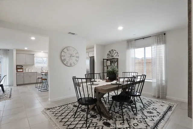 a view of a dining room with furniture and a large window