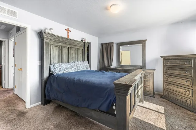 a bedroom with a bed and a dresser