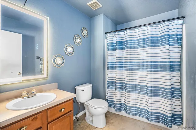 a bathroom with a sink a toilet and mirror