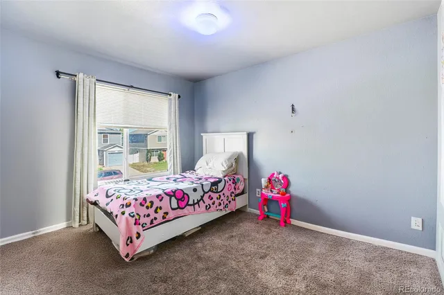 a bedroom with bed and a window