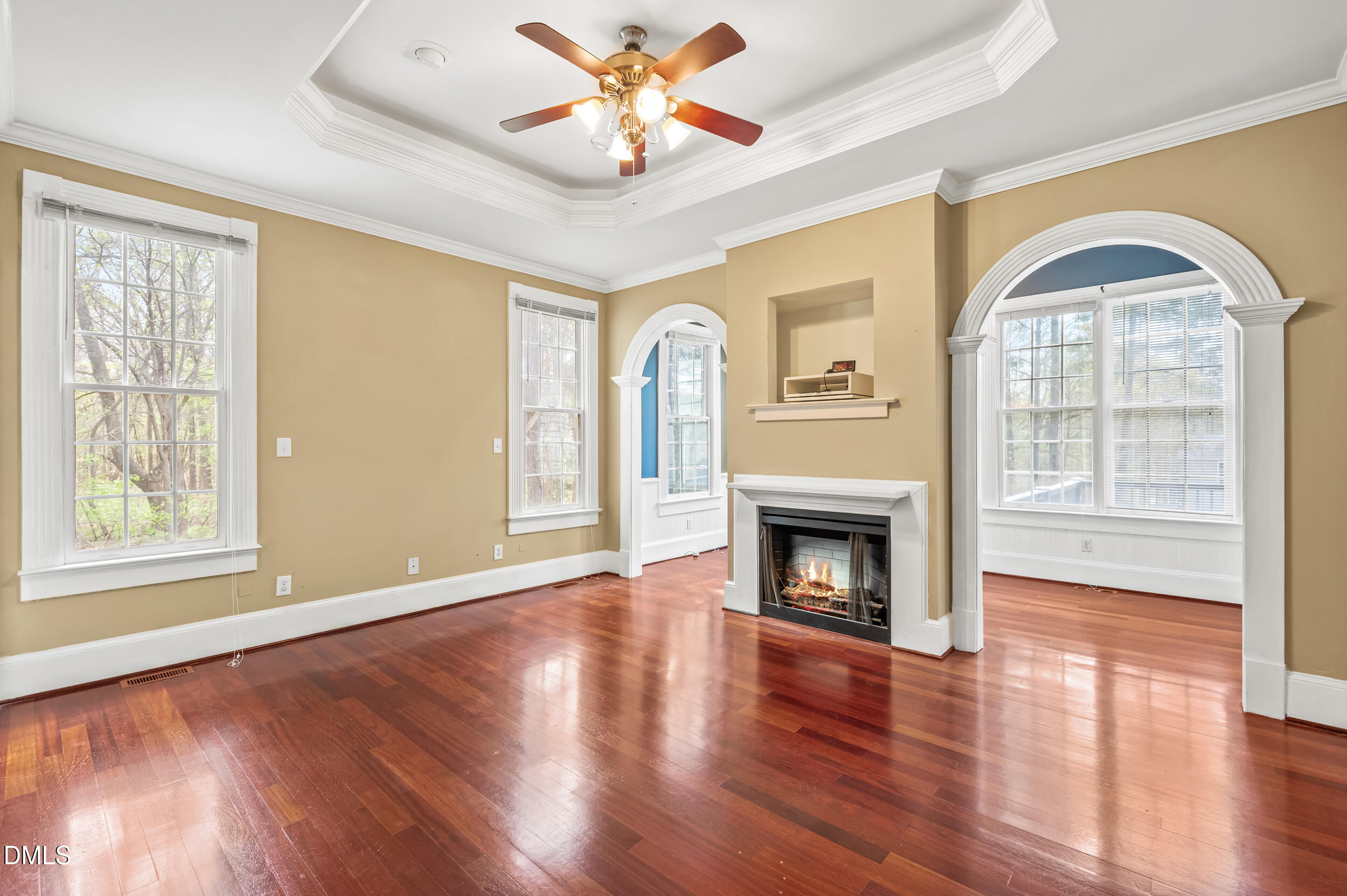 1957 Hilltop Road Raleigh, NC 27610 - Photo 15 of 46 a view of an empty room with wooden floor fireplace and a window