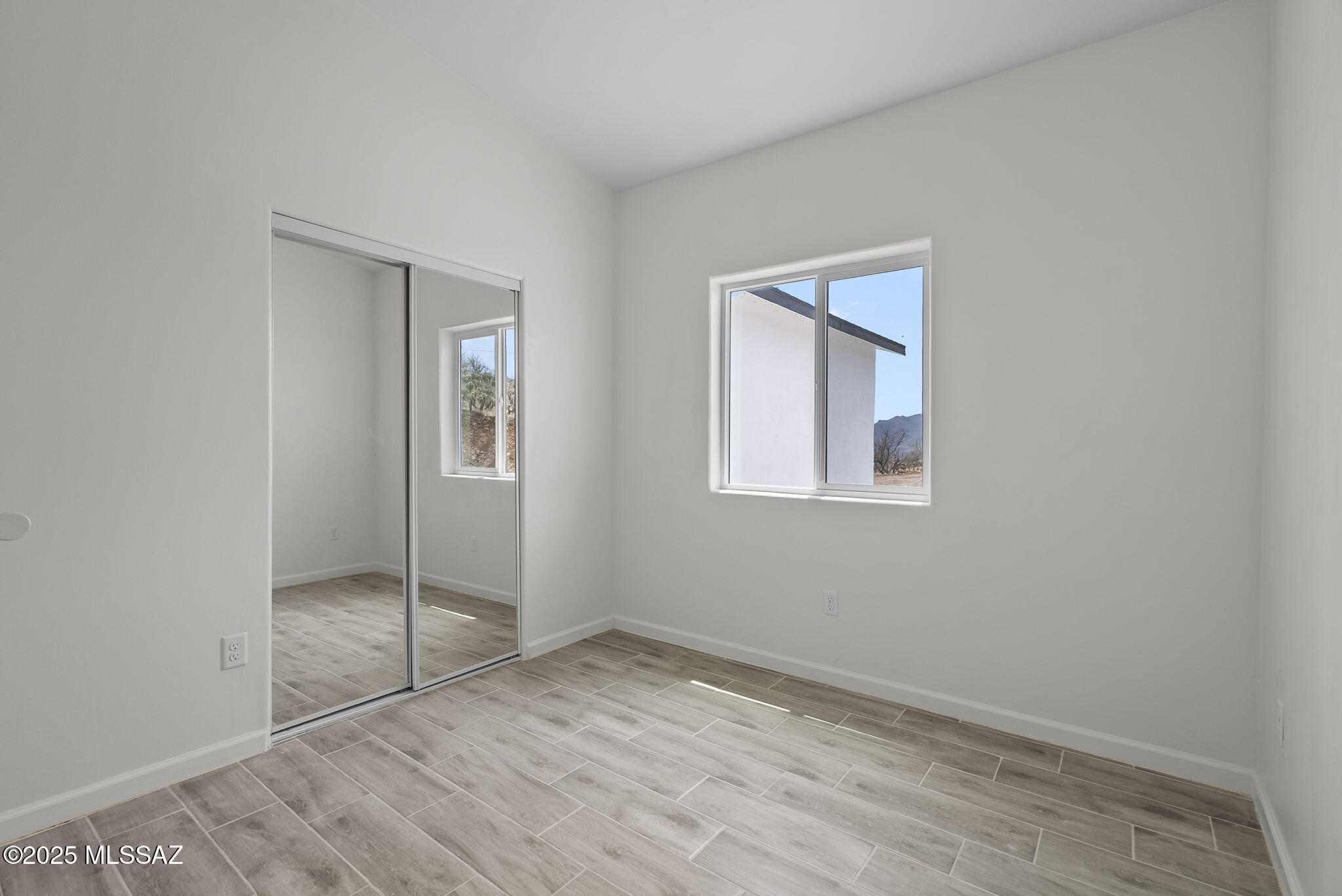 1895 Roma Court Rio Rico, AZ 85648 - Photo 29 of 42 an empty room with windows and closet