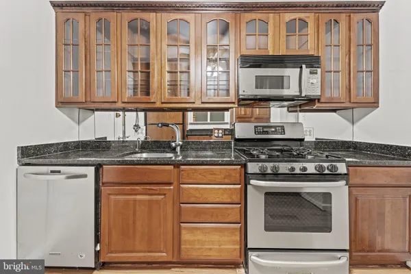 a kitchen with stainless steel appliances granite countertop a stove and a refrigerator