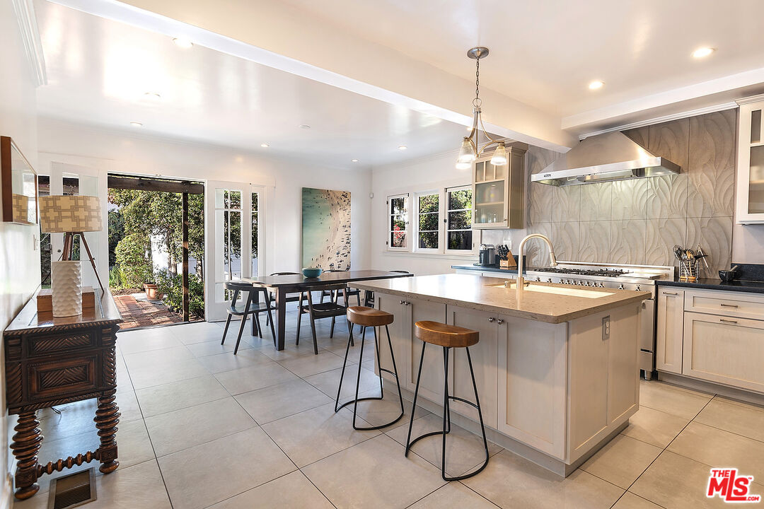 1927 Buckingham Road Los Angeles, CA 90016 - Photo 12 of 36 a kitchen with center island table and chairs