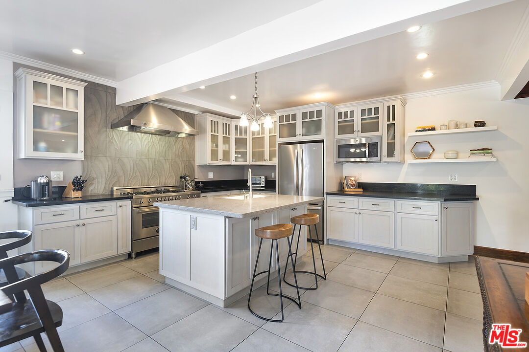 1927 Buckingham Road Los Angeles, CA 90016 - Photo 15 of 36 a kitchen with a sink and cabinets