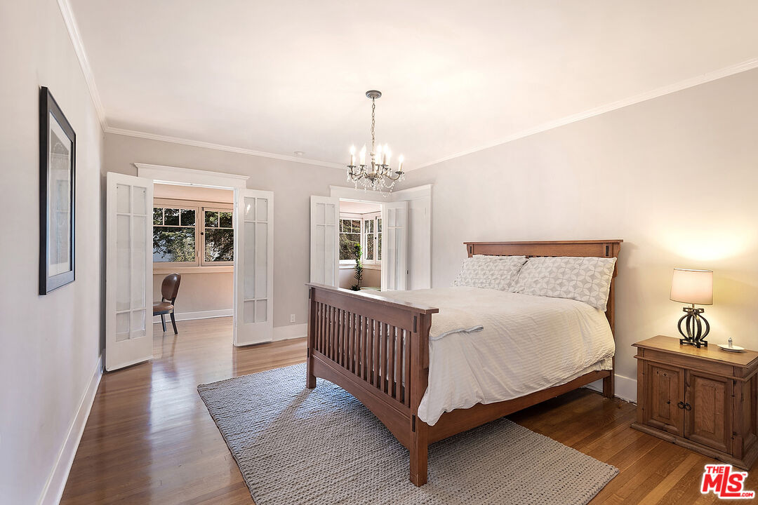 1927 Buckingham Road Los Angeles, CA 90016 - Photo 24 of 36 a spacious bedroom with a bed and wooden floor