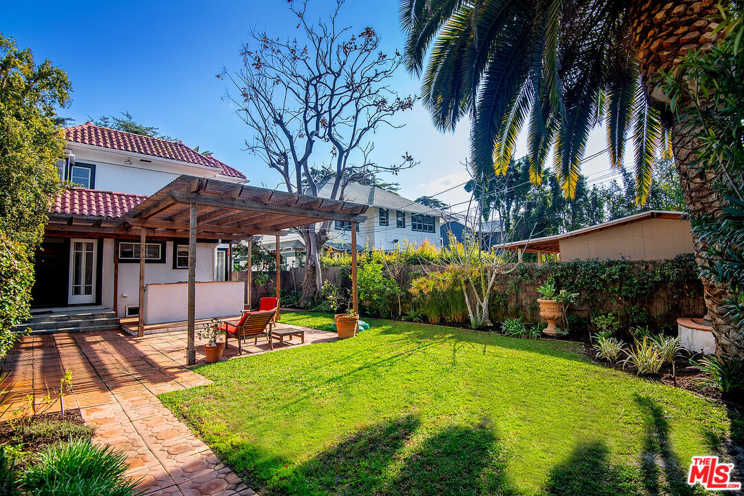 1927 Buckingham Road Los Angeles, CA 90016 - Photo 31 of 36 a view of a house with swimming pool and sitting area