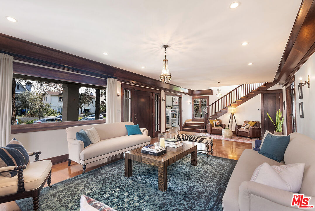 1927 Buckingham Road Los Angeles, CA 90016 - Photo 5 of 36 a living room with furniture and floor to ceiling windows