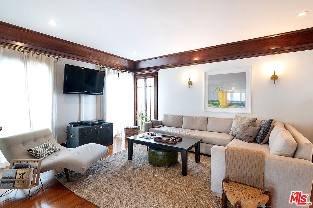 1927 Buckingham Road Los Angeles, CA 90016 - Photo 9 of 36 a living room with furniture and a flat screen tv