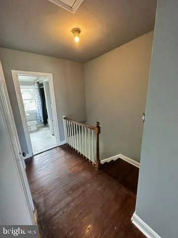 an entryway in a hall with wooden floor