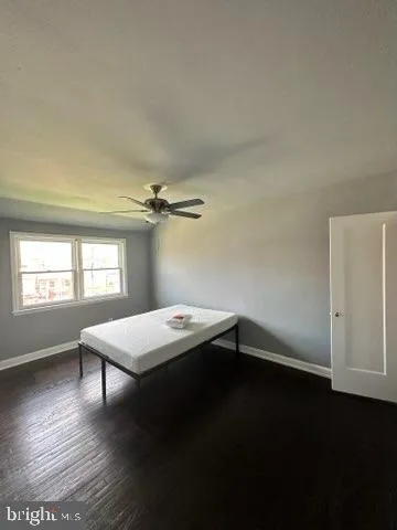 a room with a wooden floor and a window