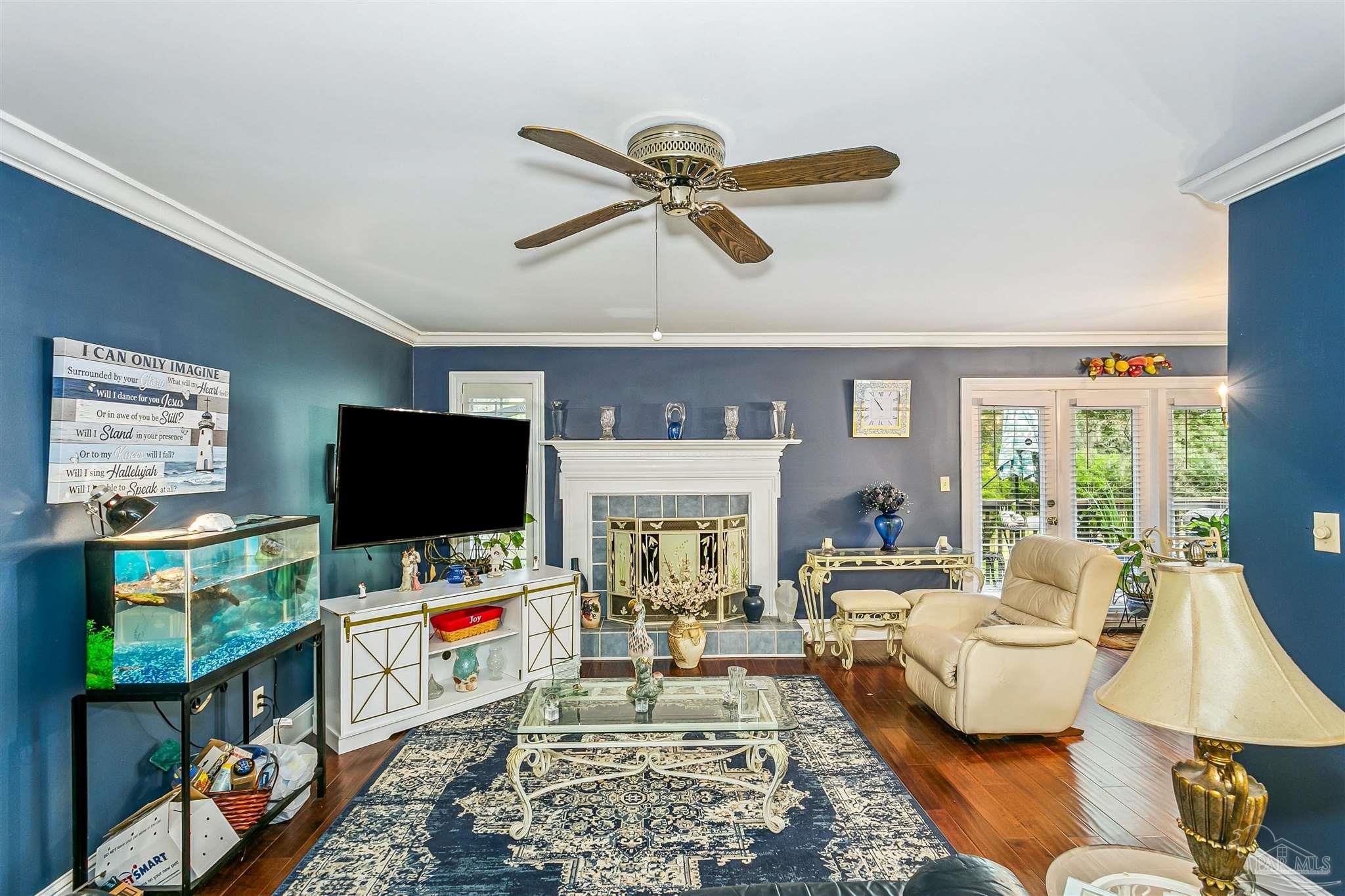 4831 East Olive Road, Unit 2D Pensacola, FL 32514 - Photo 11 of 29 a living room with furniture and a flat screen tv