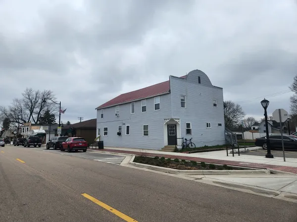 a large building with a large window and parking space