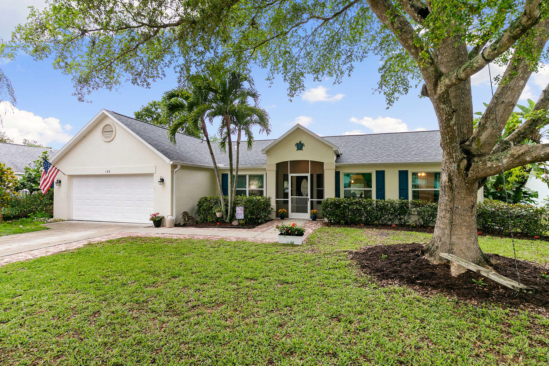 159 Plantation Circle Naples, FL 34104 - Photo 1 of 38 a front view of a house with a yard and garage