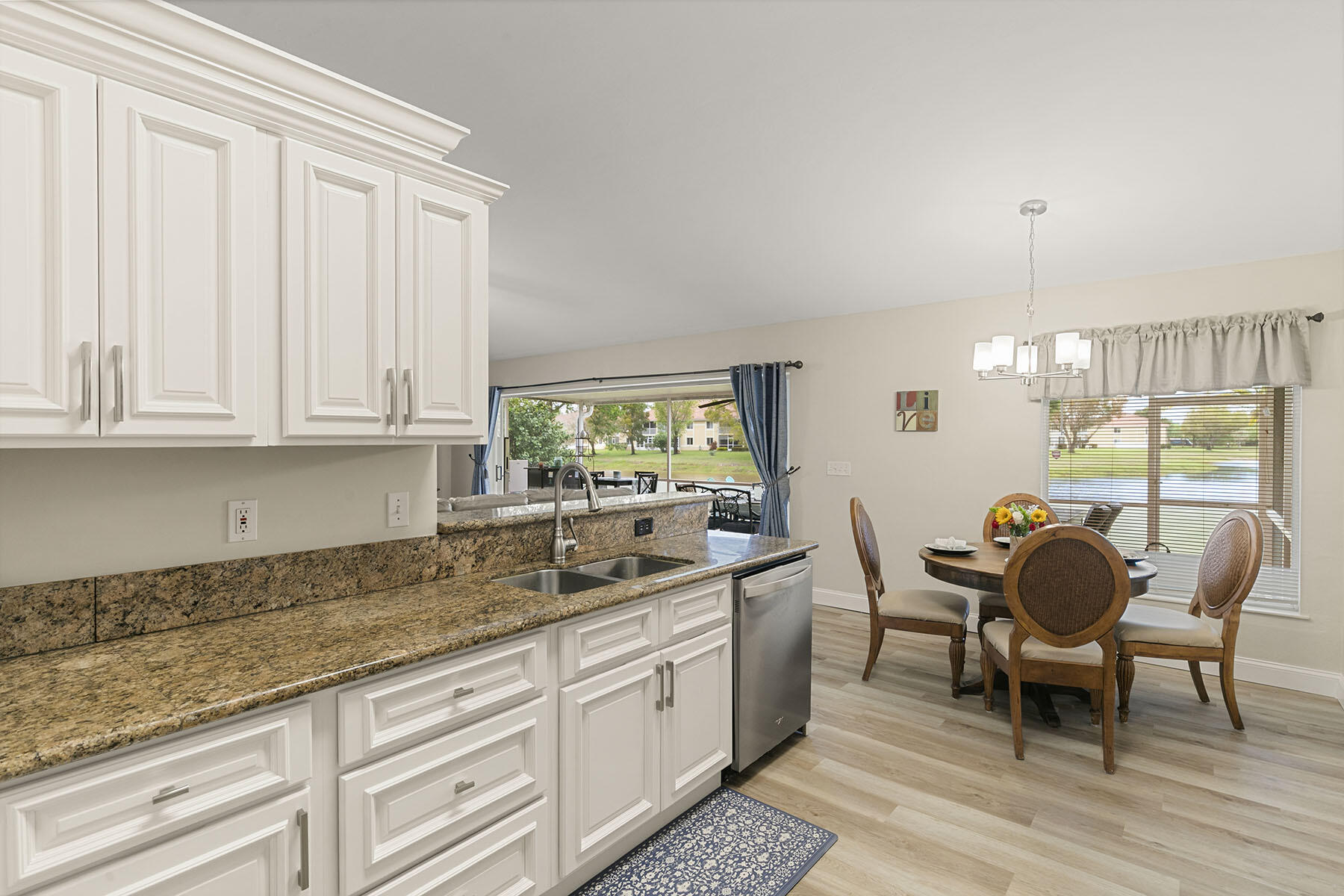 159 Plantation Circle Naples, FL 34104 - Photo 13 of 38 a kitchen with stainless steel appliances granite countertop a sink and cabinets