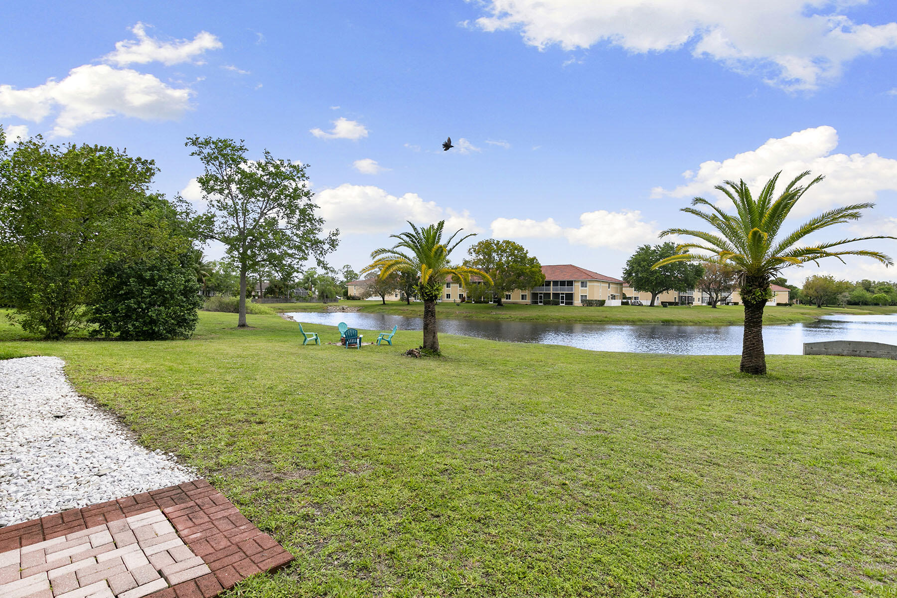 159 Plantation Circle Naples, FL 34104 - Photo 27 of 38 a green field with lots of trees in the background