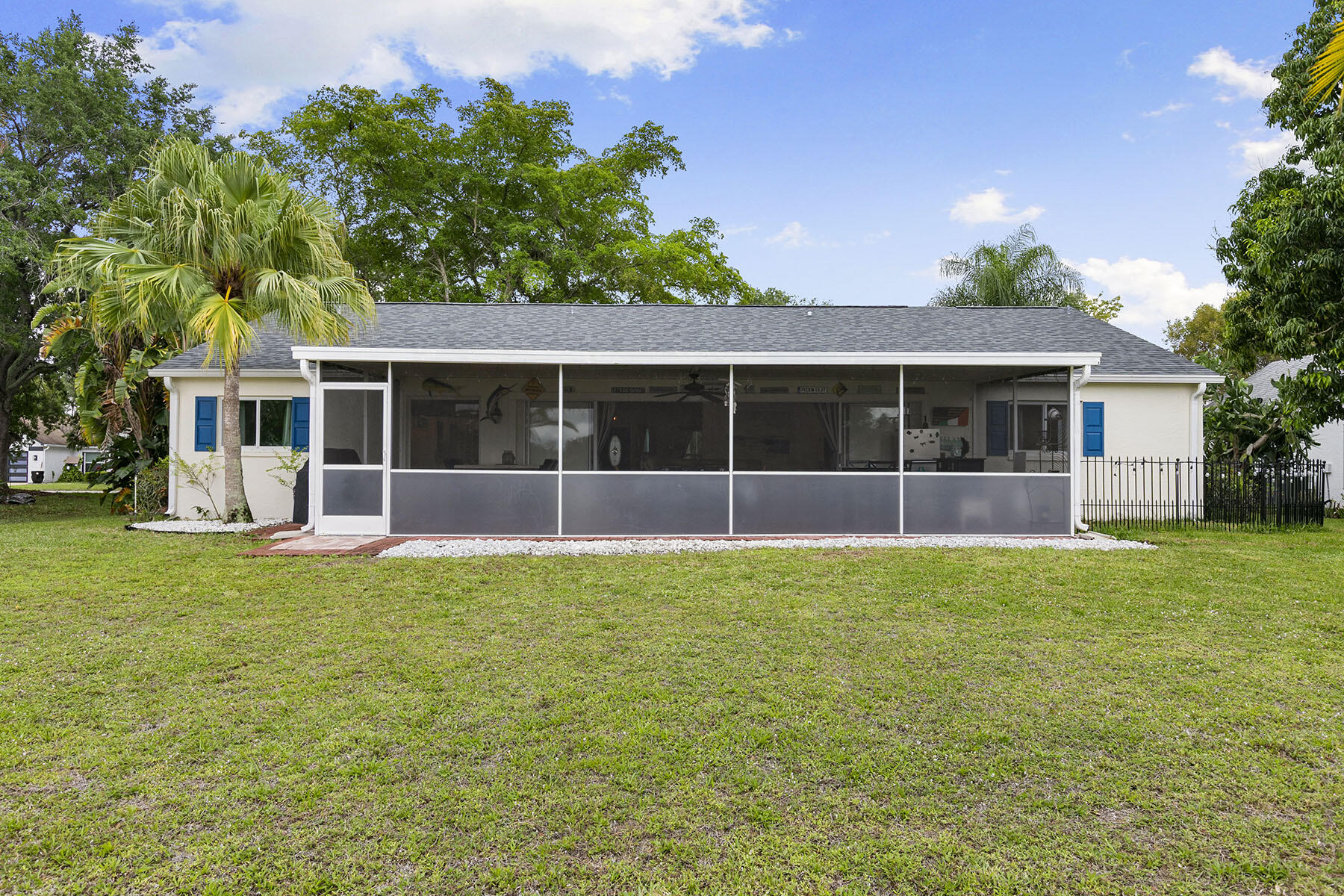 159 Plantation Circle Naples, FL 34104 - Photo 28 of 38 a front view of a house with a garden
