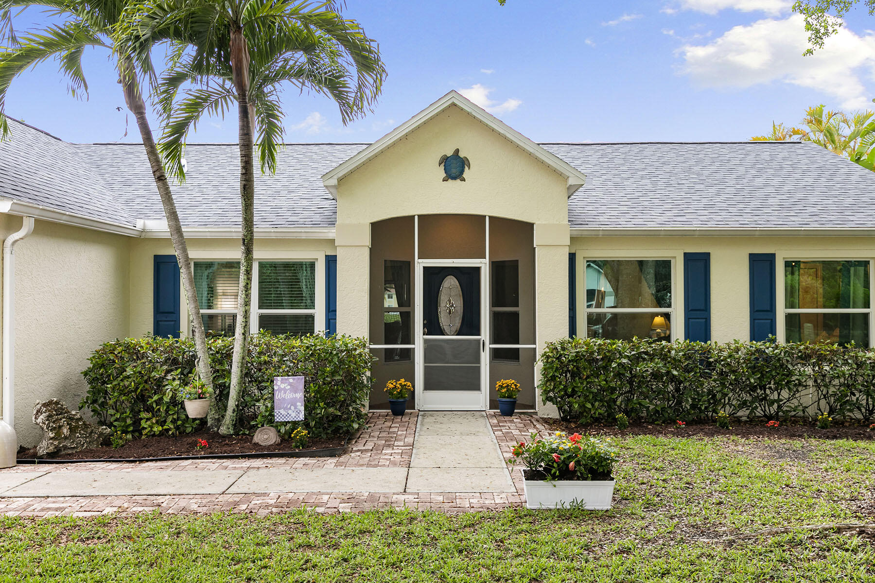 159 Plantation Circle Naples, FL 34104 - Photo 29 of 38 a front view of a house with a yard and potted plants