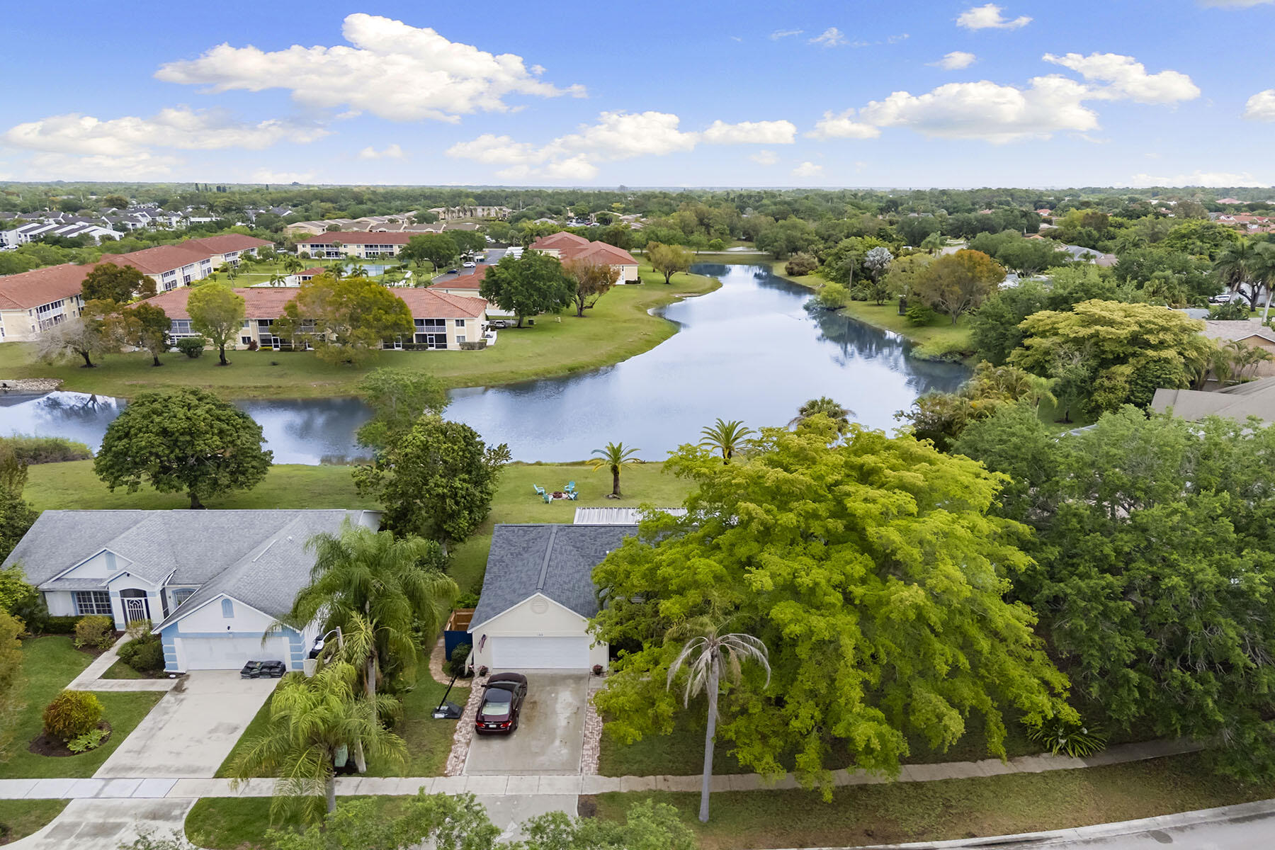 159 Plantation Circle Naples, FL 34104 - Photo 31 of 38 an aerial view of residential houses with outdoor space and lake view