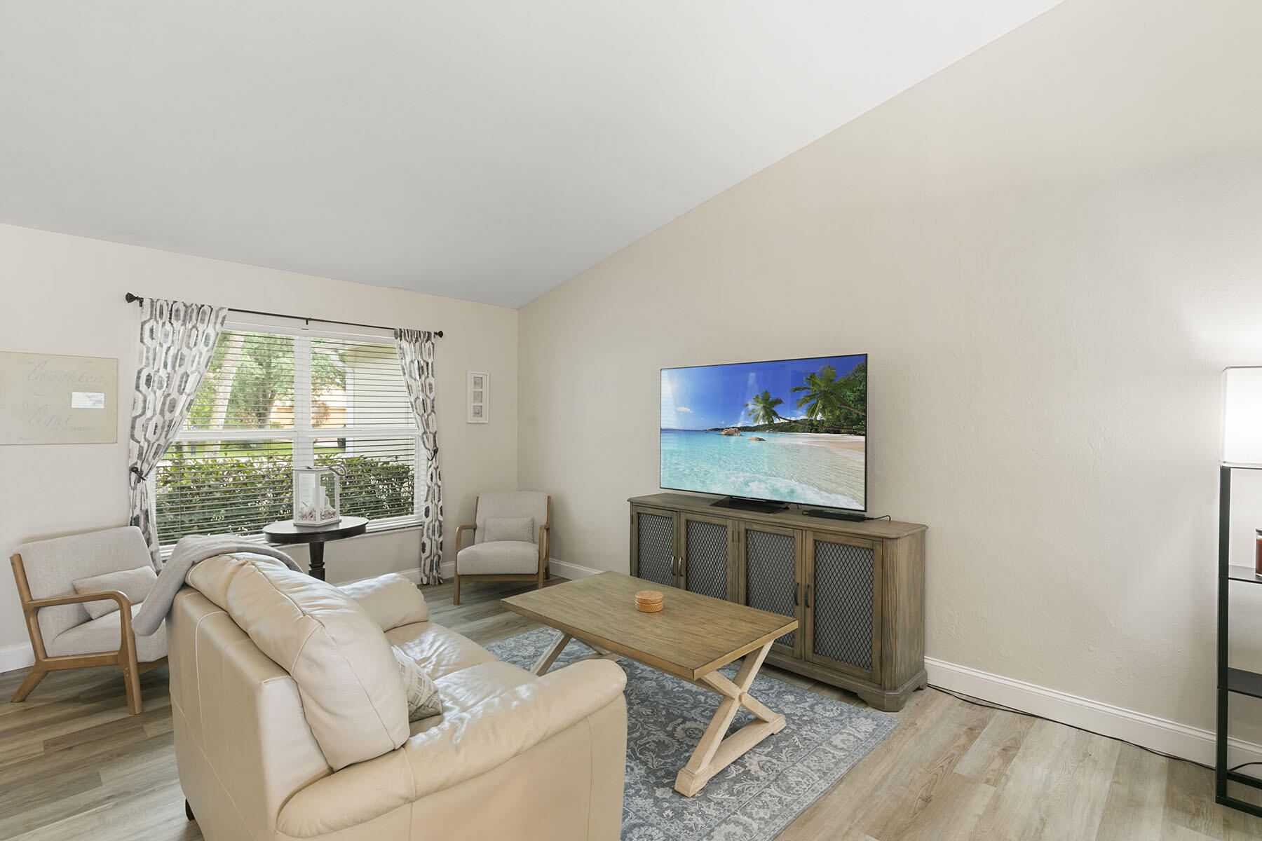 159 Plantation Circle Naples, FL 34104 - Photo 9 of 38 a living room with furniture a window and a flat screen tv