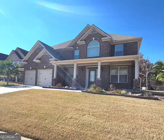 a front view of a house with a yard