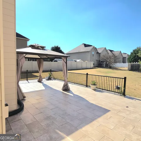 a view of a backyard with sitting area