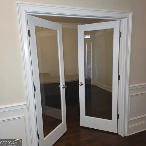 a bathroom with a glass door and mirror