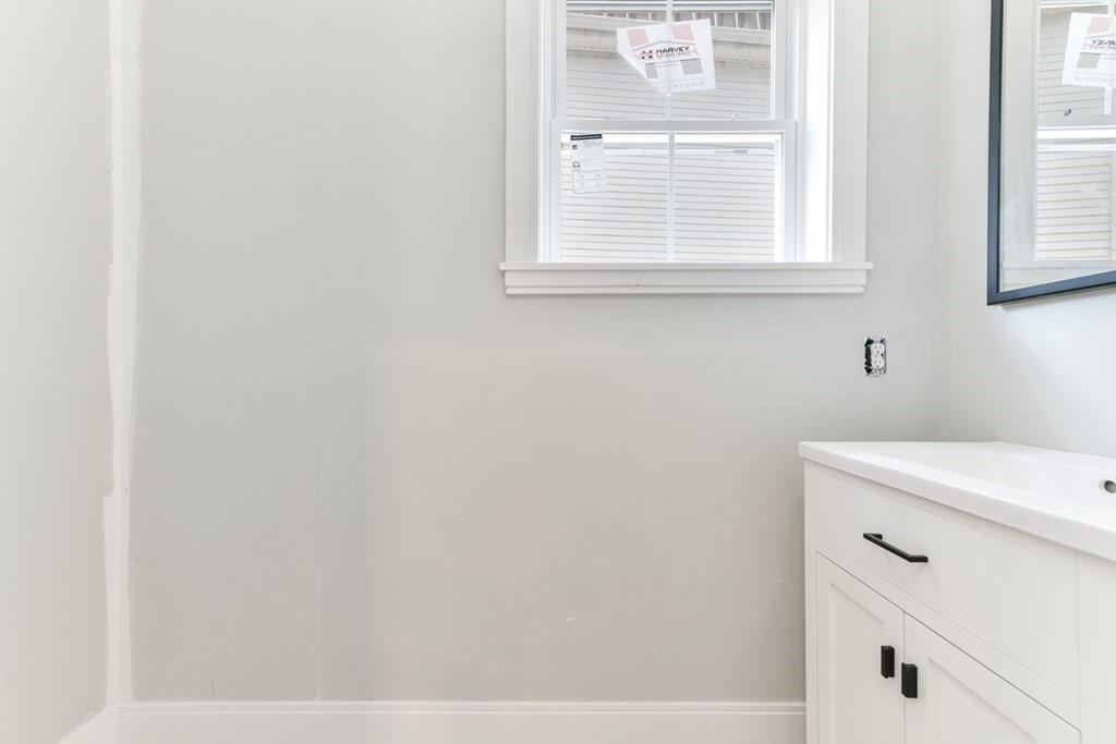 14 Ennis Road, Unit REAR Boston, MA 02119 - Photo 12 of 26 a bathroom with a sink and a window
