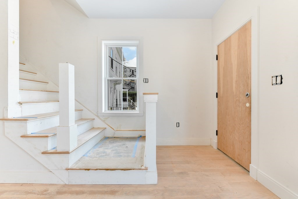 14 Ennis Road, Unit REAR Boston, MA 02119 - Photo 13 of 26 a view of entryway and hall with wooden floor