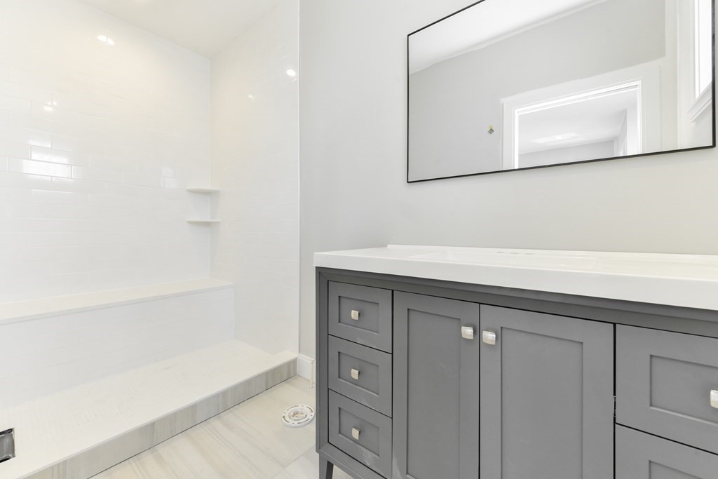 14 Ennis Road, Unit REAR Boston, MA 02119 - Photo 16 of 26 a bathroom with a sink and a mirror
