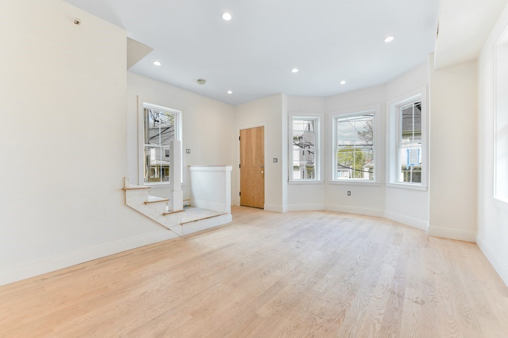 14 Ennis Road, Unit REAR Boston, MA 02119 - Photo 3 of 26 an empty room with windows and cabinet