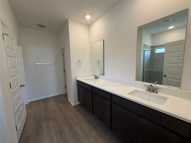 a bathroom with a double vanity sink and mirror