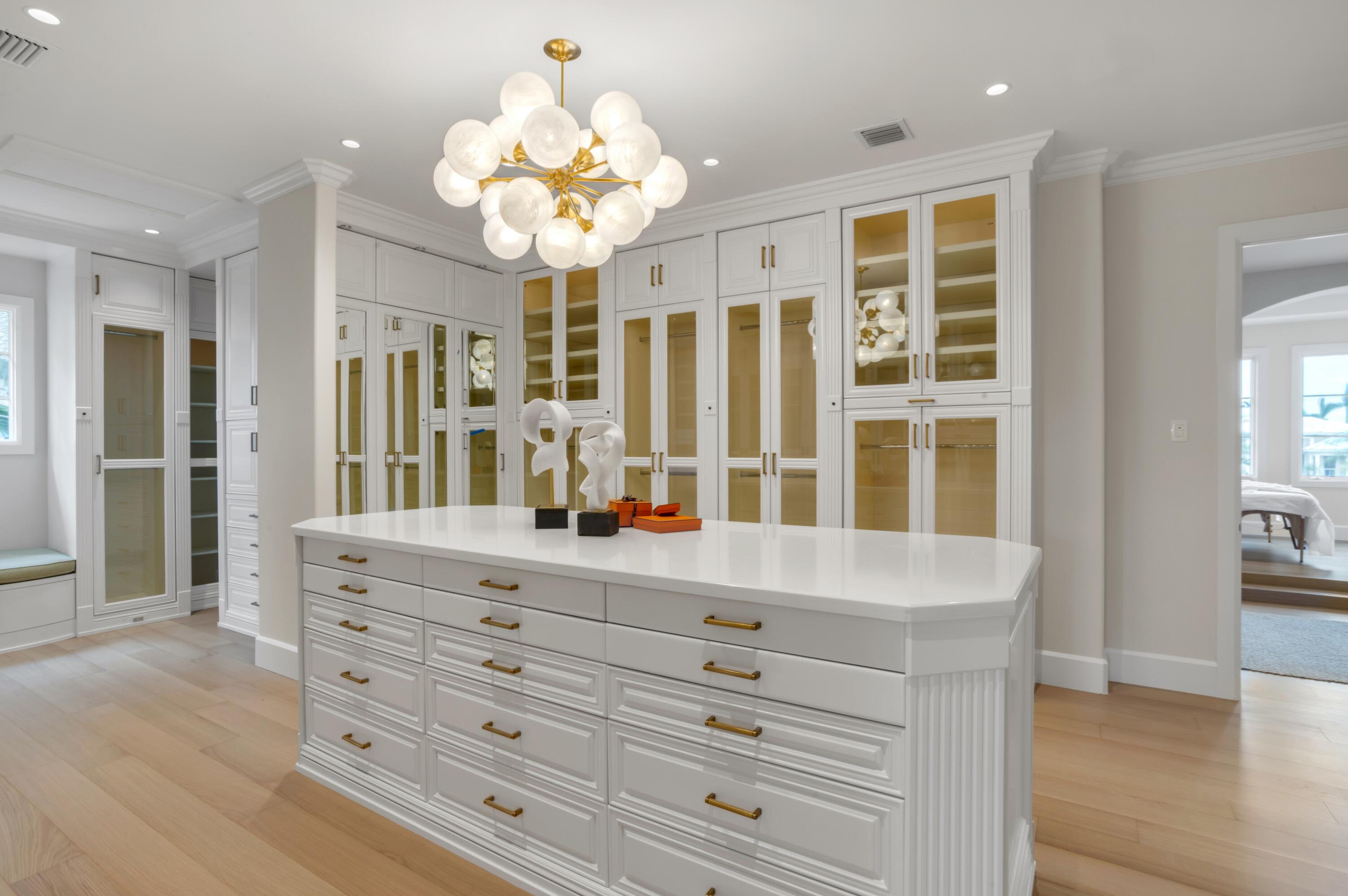1203 Spanish River Road Boca Raton, FL 33432 - Photo 9 of 30 a view of a hallway vanity and chandelier