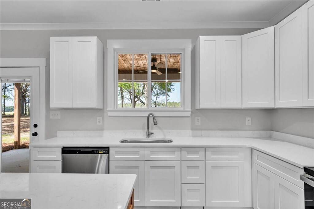 2769 Claxton Dairy Road Dublin, GA 31021 - Photo 11 of 48 a kitchen with granite countertop white cabinets and white appliances