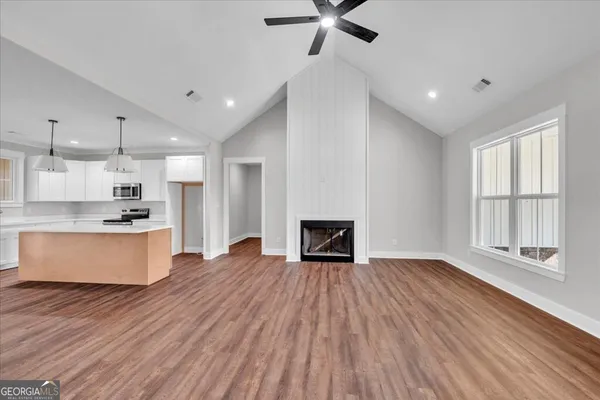 a view of kitchen with sink and wooden floor