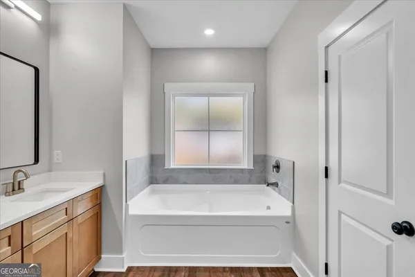 a bathroom with a bathtub and a sink