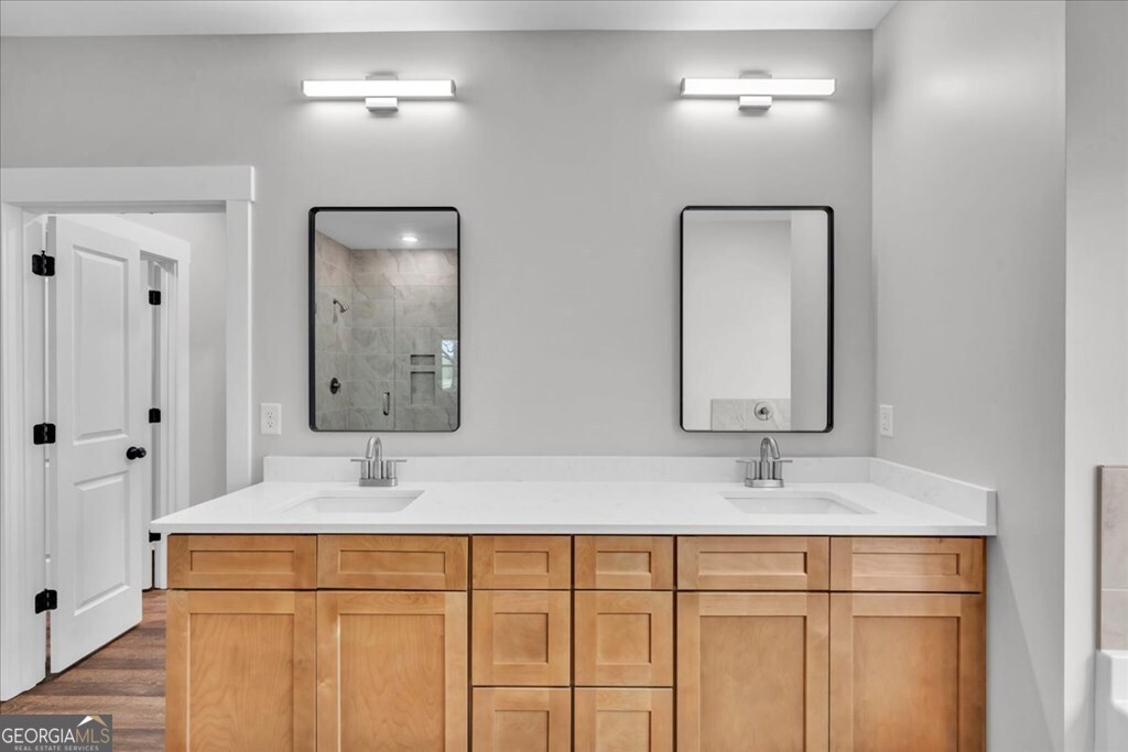 2769 Claxton Dairy Road Dublin, GA 31021 - Photo 25 of 48 a bathroom with double vanity sink and a mirror