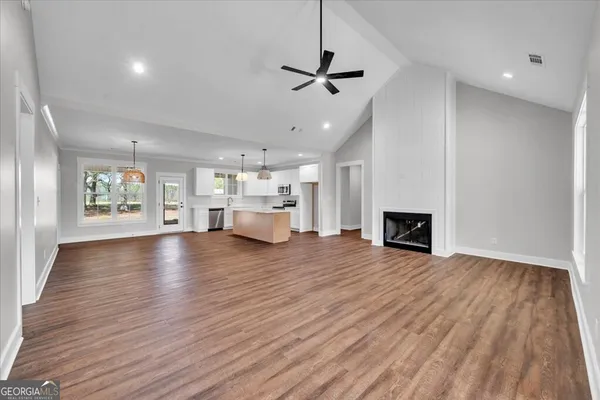 a view of kitchen and hall with wooden floor