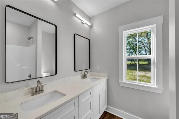 a bathroom with 2 sink and a mirror