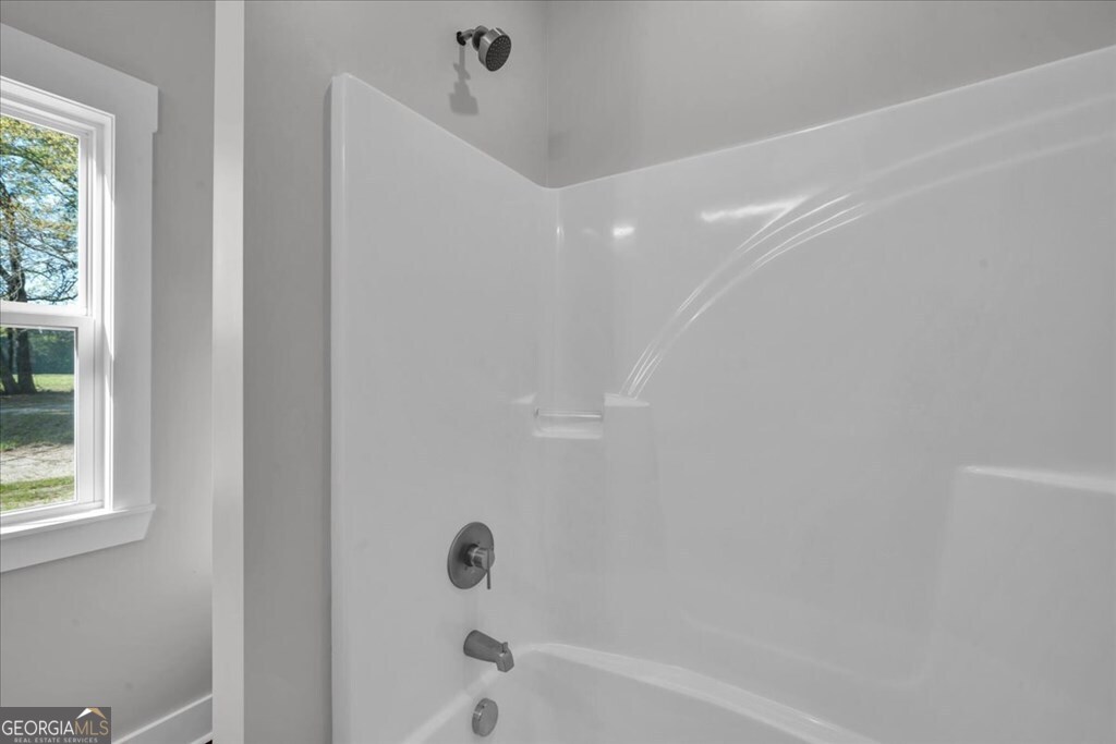 2769 Claxton Dairy Road Dublin, GA 31021 - Photo 32 of 48 a bathroom with a bathtub and a shower